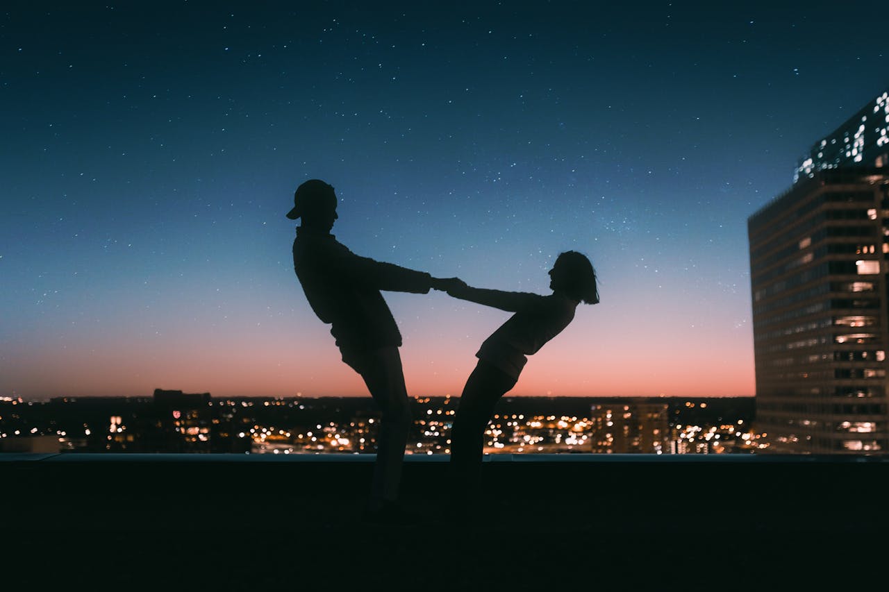 Silhouette of Man Jumping on Field during Night Time